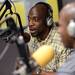 Former Michigan football player Tim Massaquoi speaks on the air at WTKA 1050 during a fundraiser for Mott Children's Hospital at the station on Friday. Melanie Maxwell I AnnArbor.com